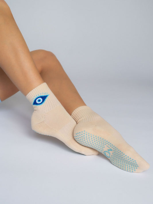 Women's non-slip grip socks for Pilates and yoga – creamy with evil eye logo
